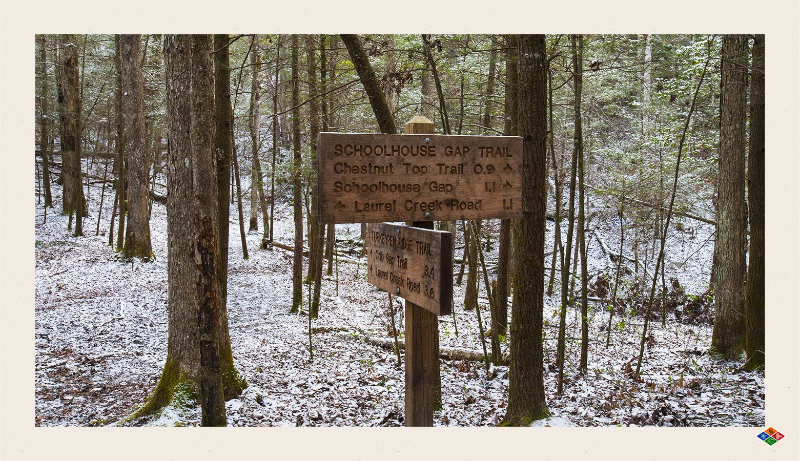 Schoolhouse Gap Trail sign in a snowy forest