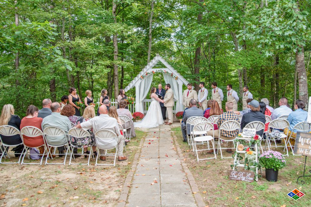 Outdoor wedding ceremony at the white arbor at Bluff Mountain Inn