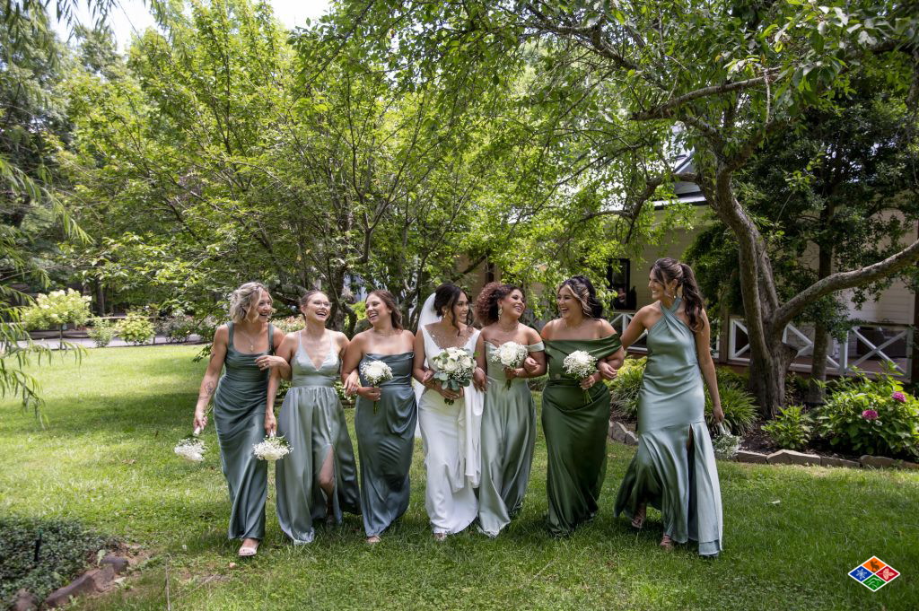 Bride and bridesmaids walking the garden path at Bluff Mountain Inn