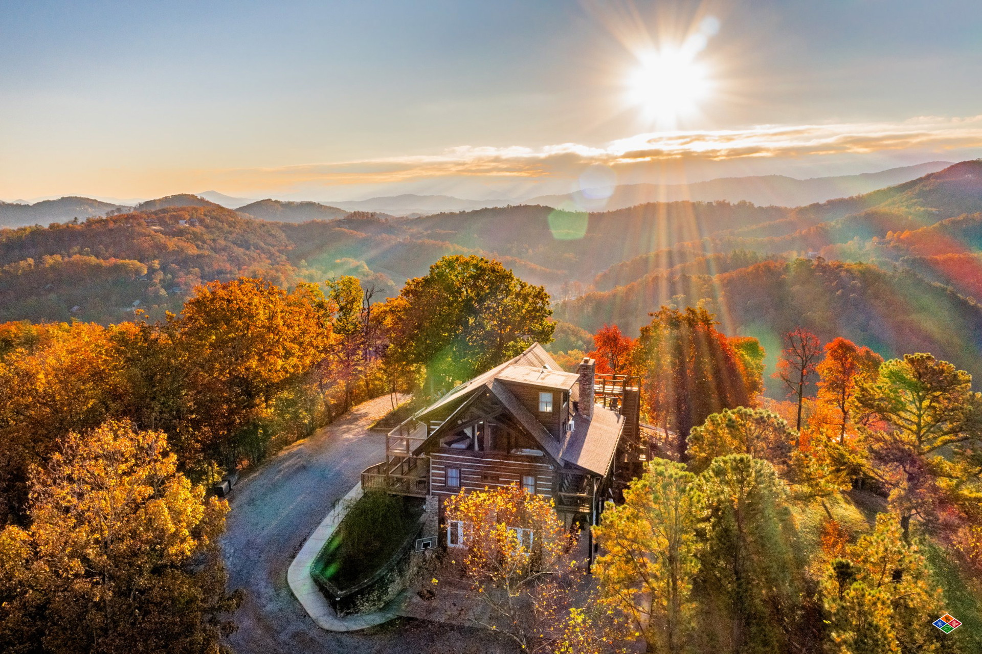 Aerial view of Cielito Lindo on its wooded mountaintop, with autumn color and the Smokies stretching to the horizon