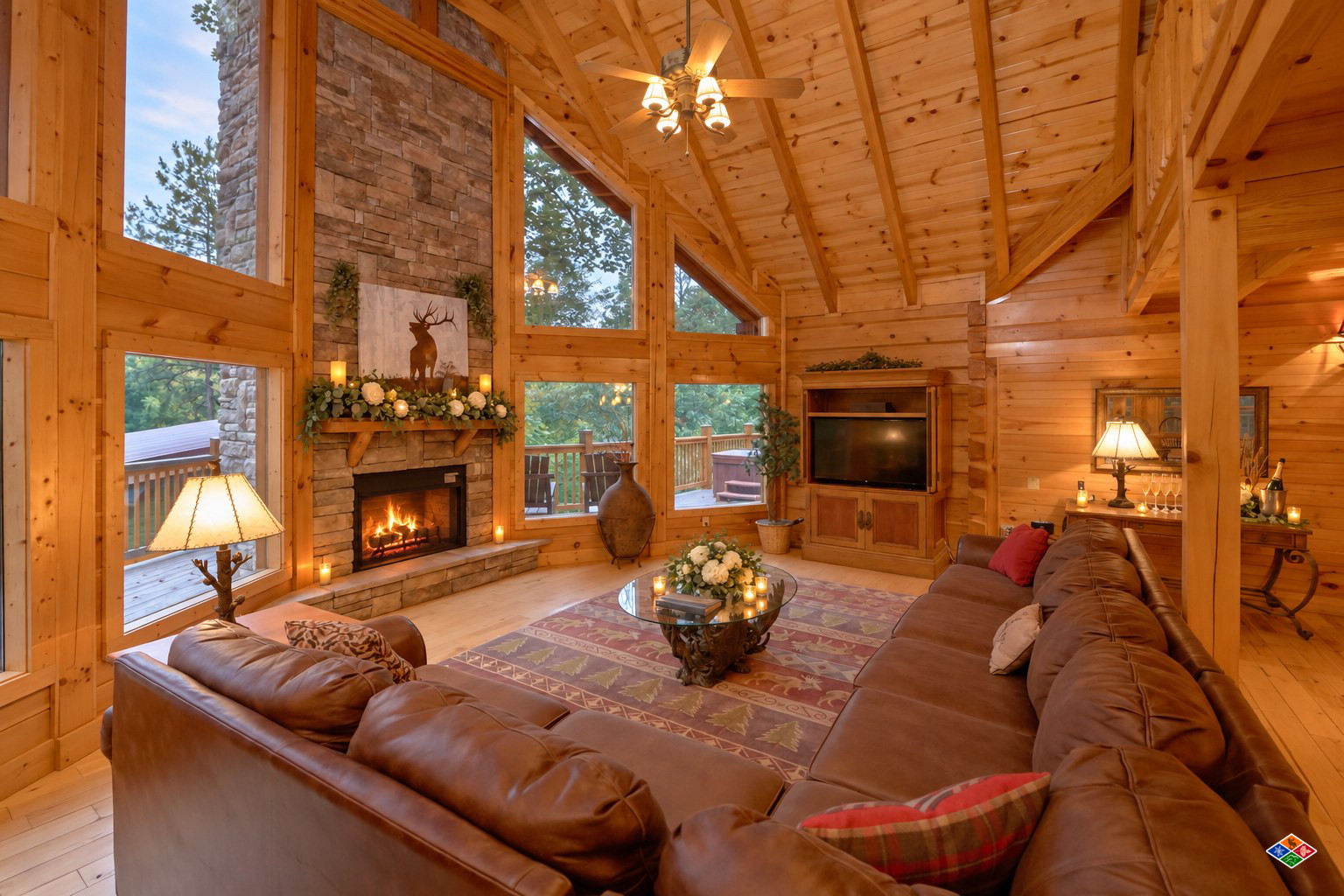 Silvercreek great room styled for a wedding with candles and white florals on the stone fireplace mantel