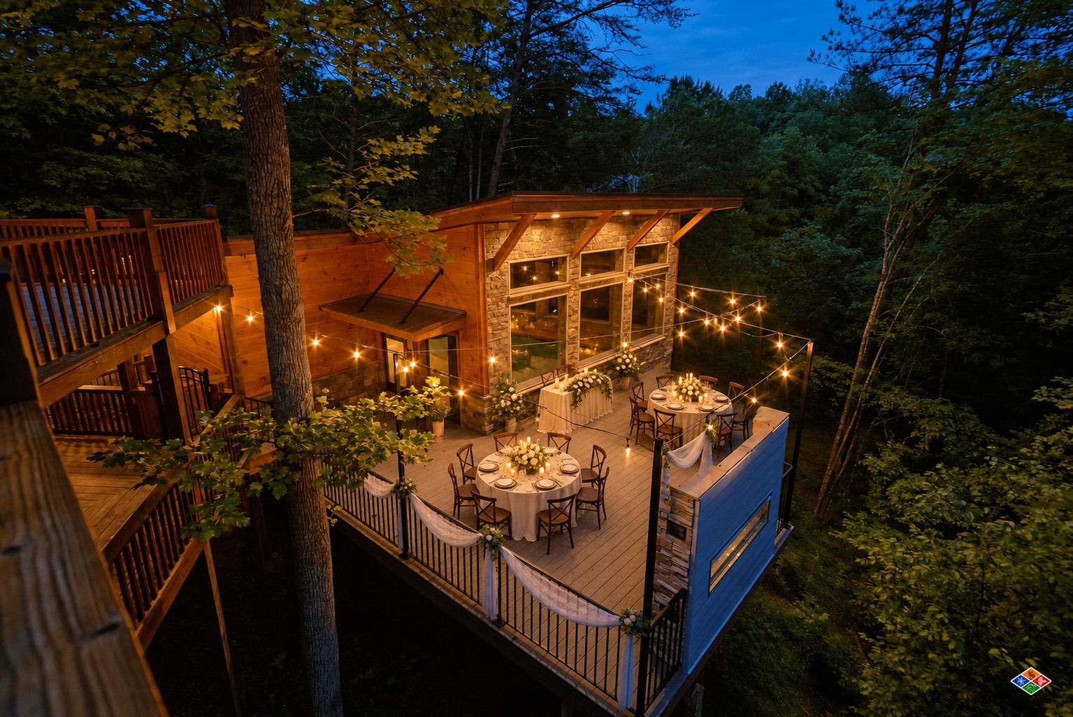 Silvercreek pool house deck at dusk set with round reception tables, white florals and string lights