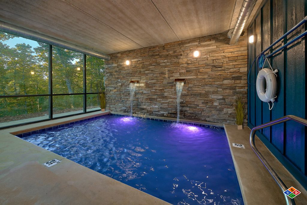 Indoor Pool with waterfall at cabin in Gatlinburg, TN