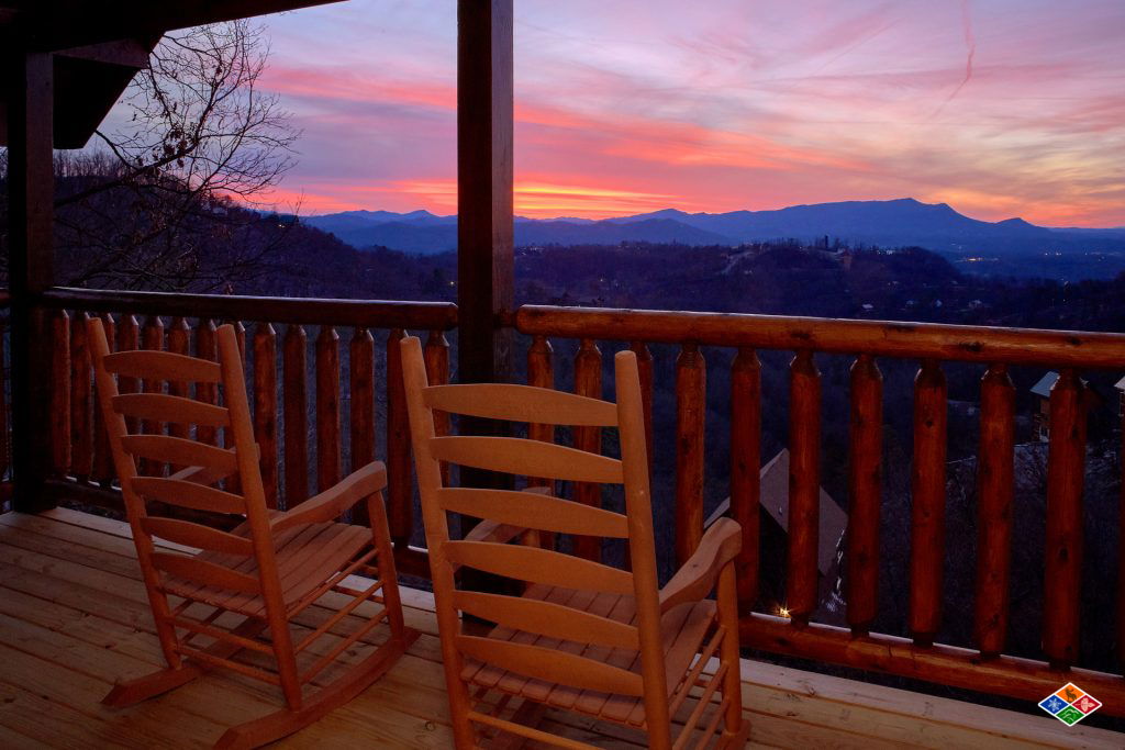 rocking chairs looking at a mountain sunset